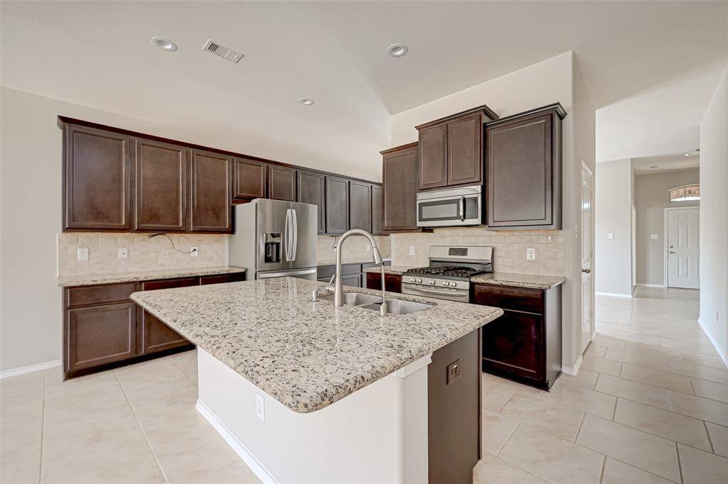 Imagine preparing meals while enjoying a view of the surrounding space and engaging with your family or guests seated around the island. The sink adds both practicality and aesthetics to the island, making it a hub for both cooking and socializing.