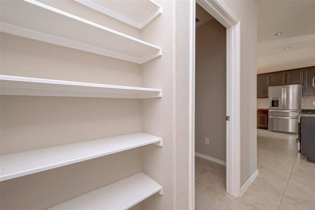 Step into a roomy pantry that provides an abundance of space to store all your kitchen essentials.