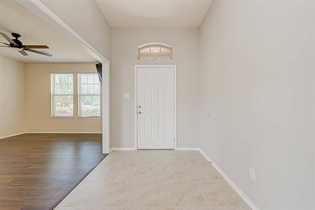 The open-concept layout seamlessly connects the living room, dining area, and kitchen, perfect for both everyday living and entertaining guests.