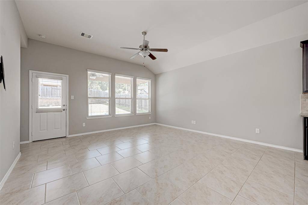 Large windows flood the interiors with natural light, enhancing the warm ambiance of the home.