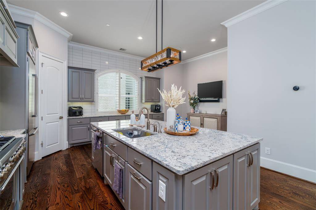 This spacious island includes a premium dishwasher, oversized sink, and abundant cabinet storage.