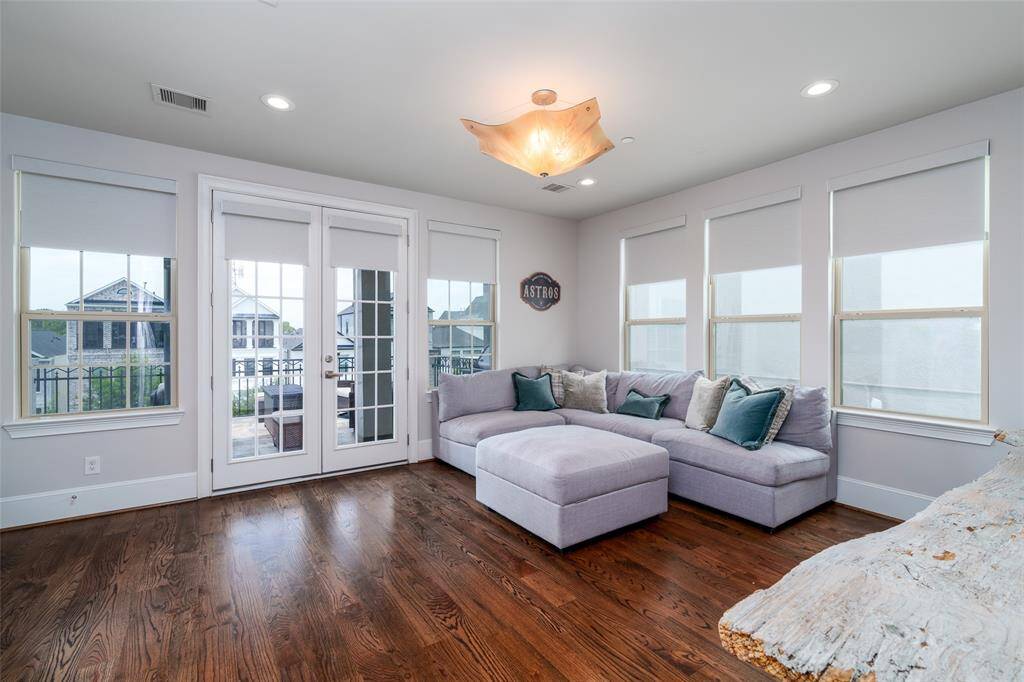The fourth-floor game room boasts abundant natural light and convenient motorized shades.