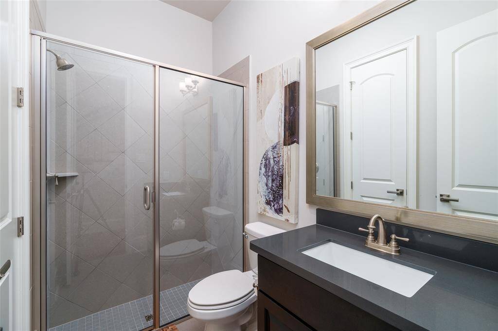 Modern first-floor bathroom featuring a sleek shower.