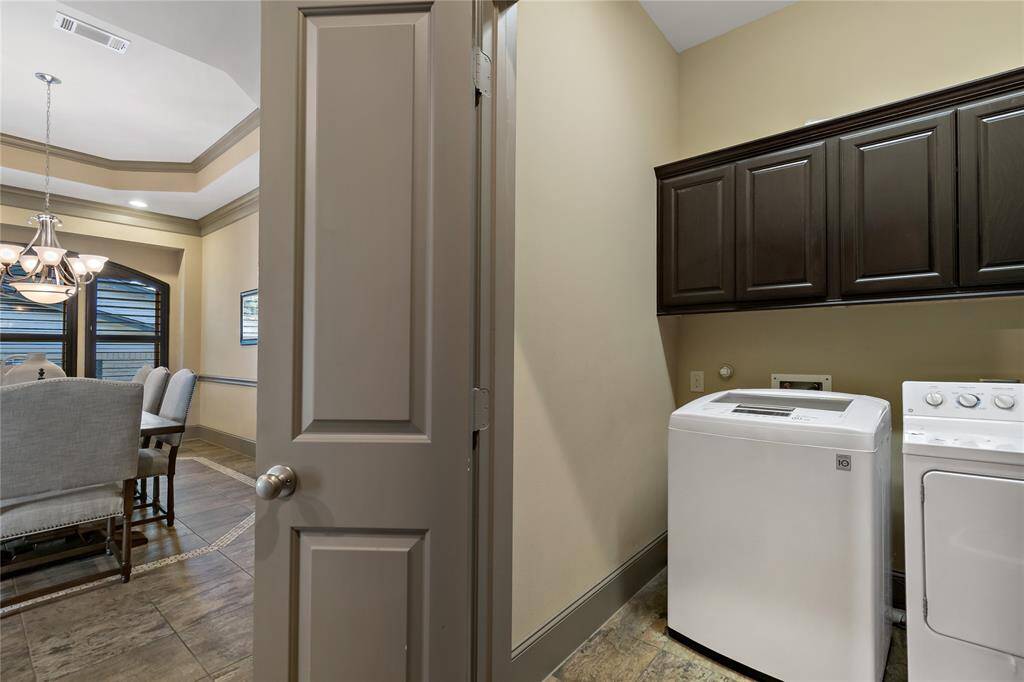 Laundry room is conveniently located near the dining room and kitchen.