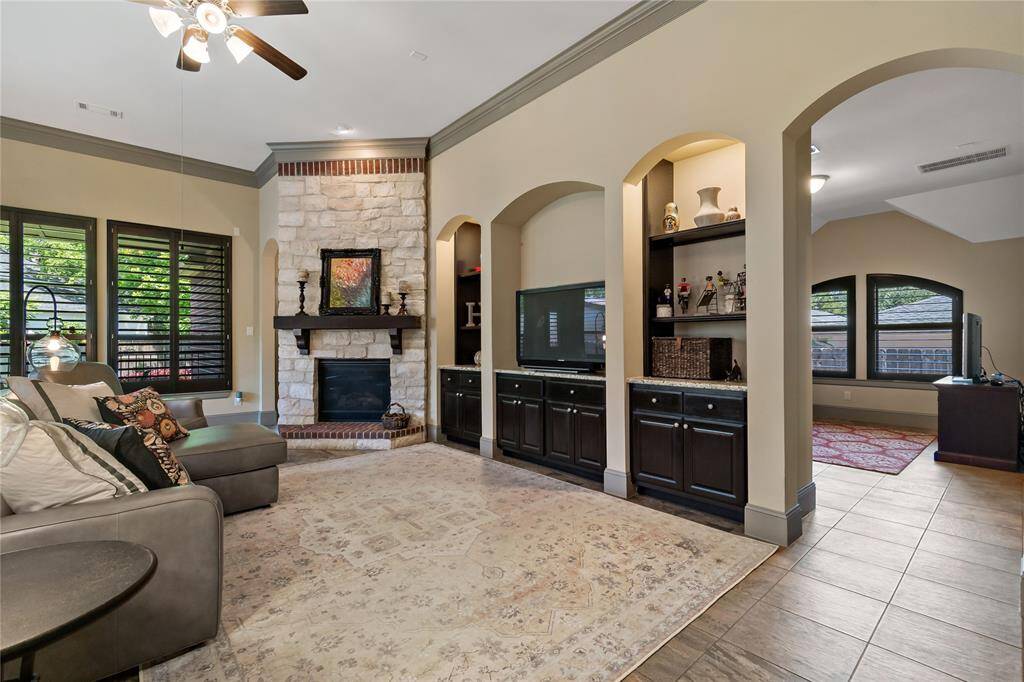 Fabulous living room has gas fireplace with gorgeous mantel and brick hearth. Great built-in cabinets  to display your precious items. TV stays