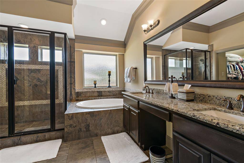 Gorgeous spa bath with two sinks, large soaking tub and large walk-in shower. Large walk-in closet off the bathroom