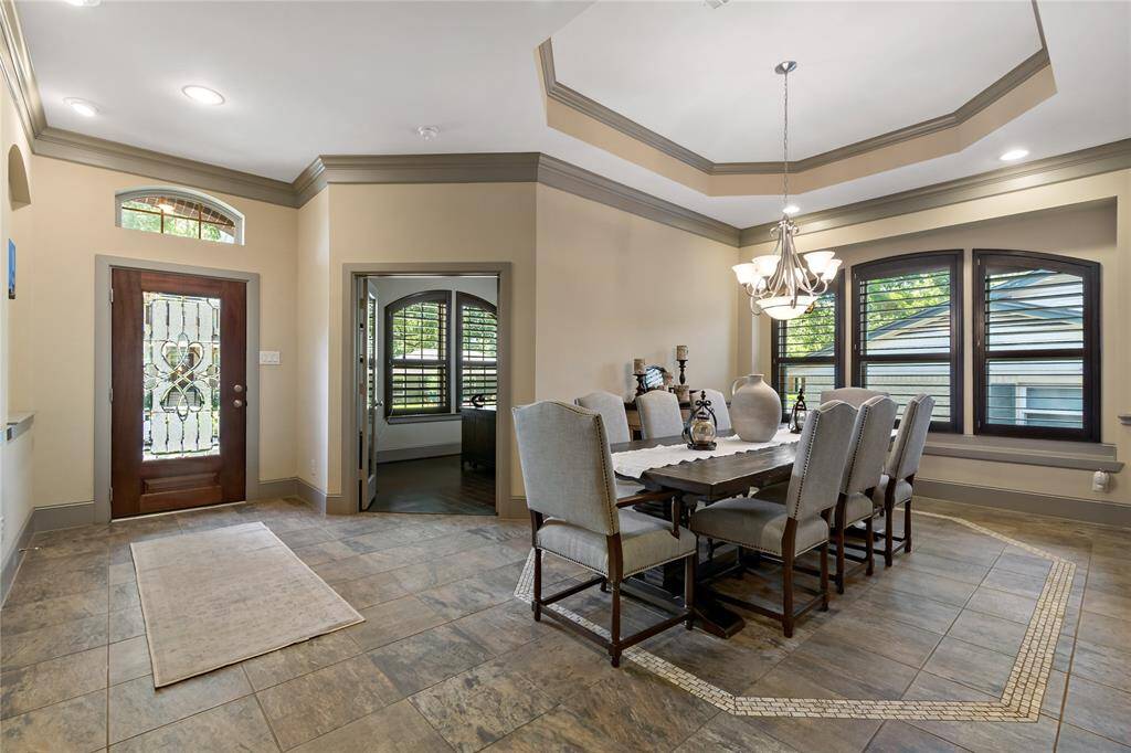 Another view of the grand dining room. The main living area has plantation shutters.