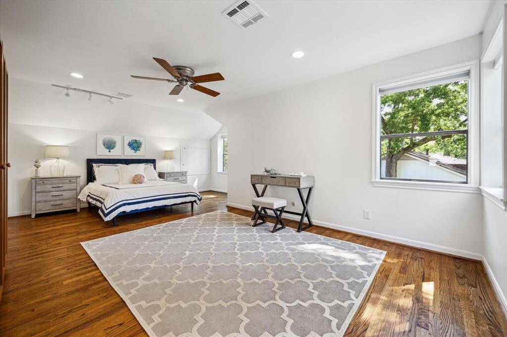 Secondary bedroom #2 is generously sized with space for a sitting area and desk. A walk-in closet and ensuite bath offer private comfort. It’s a beautifully appointed guest or family suite.