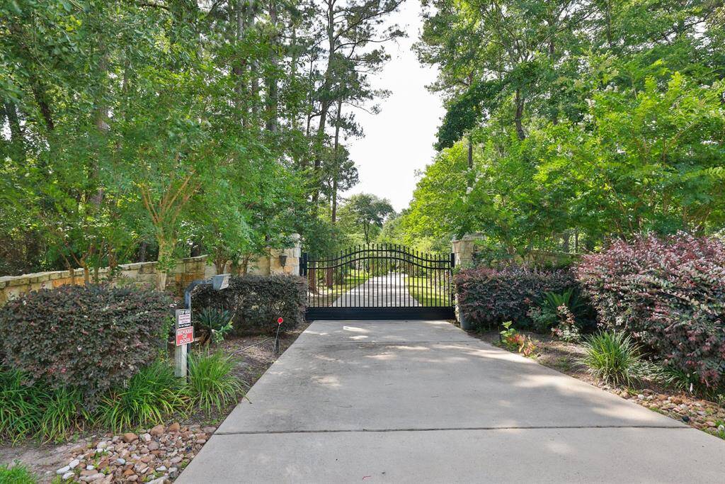 Experience unparalleled privacy with this home, featuring a gated entry and a serene, winding driveway.