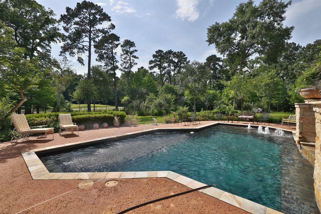 Spacious yard behind the pool, perfect for outdoor activities.