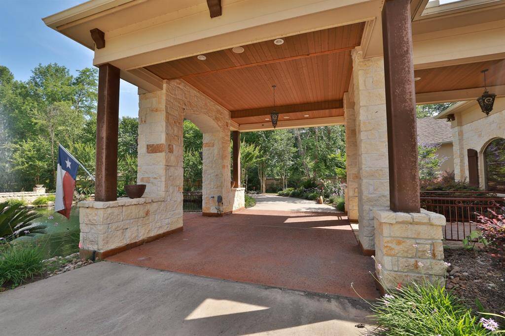 This photo showcases an elegant foyer with rich wood flooring and trim, leading into a spacious, well-lit family area. The open layout features stylish and architectural details, creating a warm and inviting atmosphere.