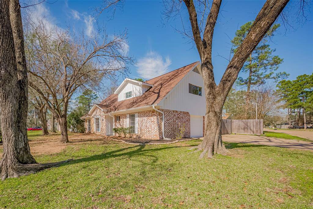 Corner lot with stately trees.