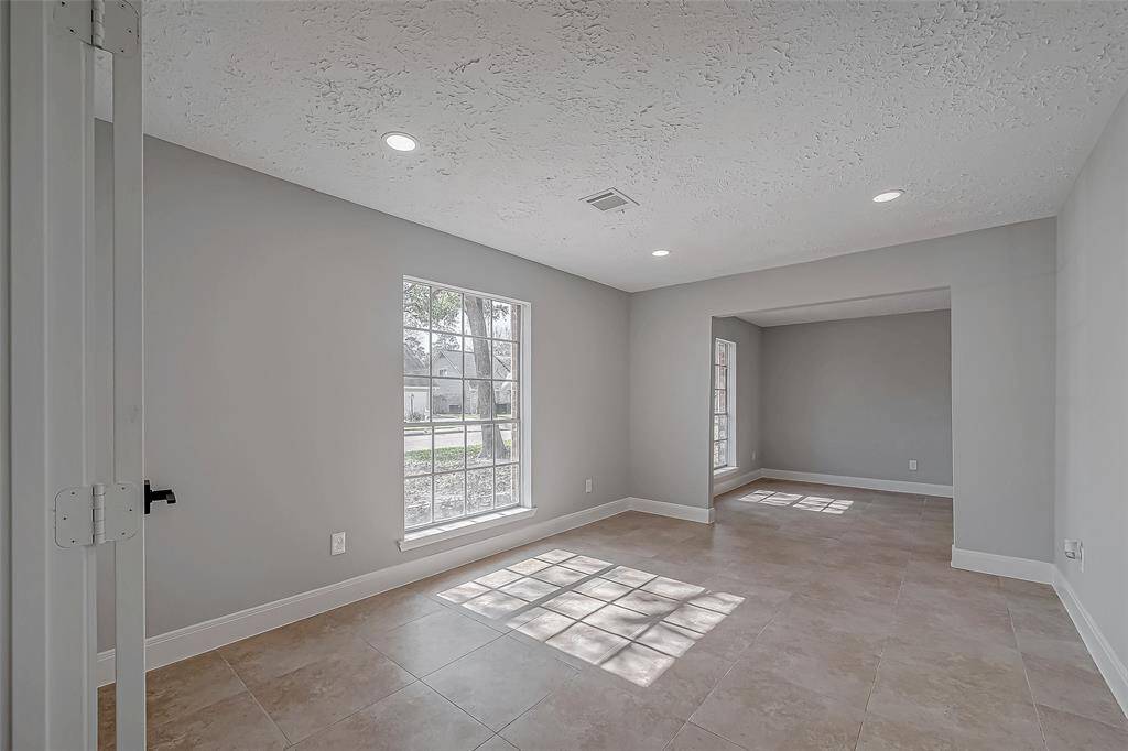 French doors off the entry lead to the formal living and dining rooms.