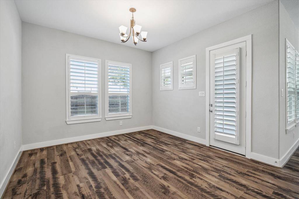 Bright and open Dining Room with French Door to back covered patio.