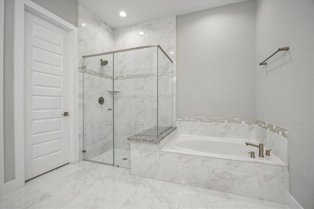 View of soaking tube and walk in shower in Primary Bedroom.
