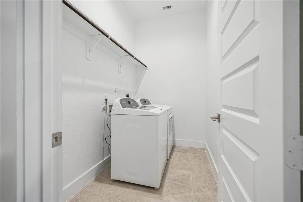Large Utility room with washer and dryer and room for a freezer.