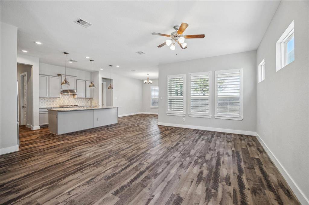 View of large Living Room open to kitchen and dining room.