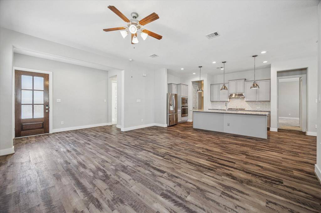 A fourth view of Living Room open to kitchen.