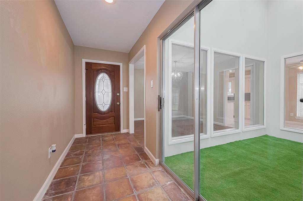 Enclosed atrium that provides a lot of natural light to the house.