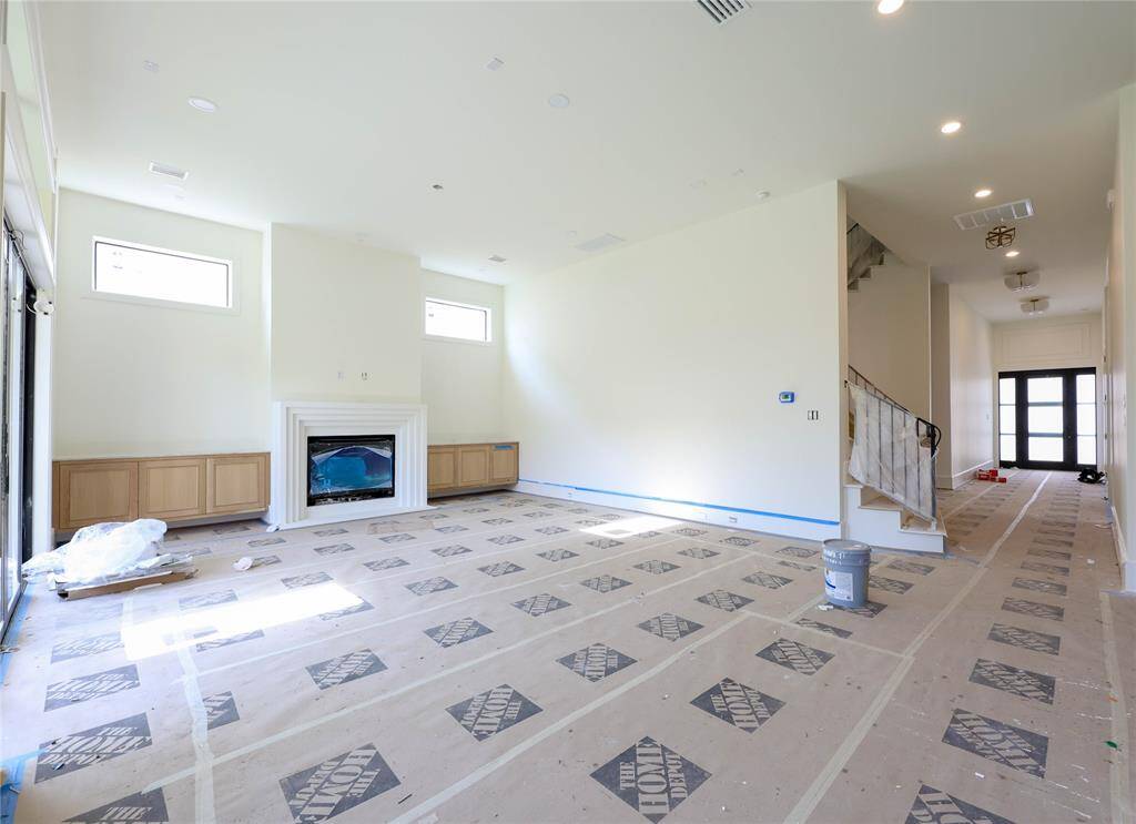 Family Room is spacious w/ living room built-ins, gas Fireplace & wall of sliding windows leading out to the covered patio & Summer Kitchen. Transoms let in an abundant amount of natural light. View #4