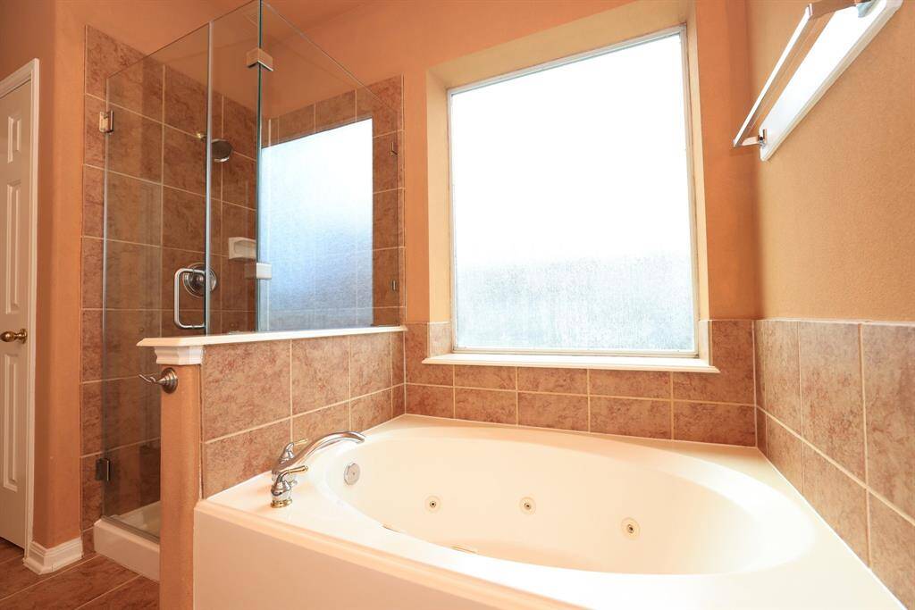 Primary bath with Exotic level granite counter and backsplash Copper sink with newer designer faucets. center drawers and lower cabinets provide optimum storage. Linen closet too