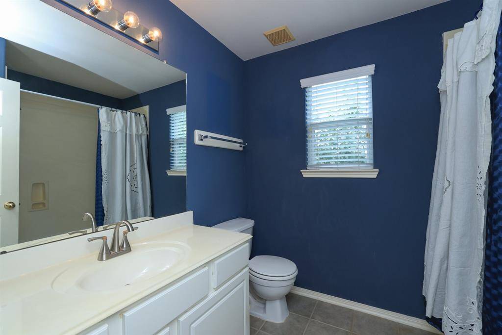 Custom paint treatment, carpeted floors and triple windows in this gameroom