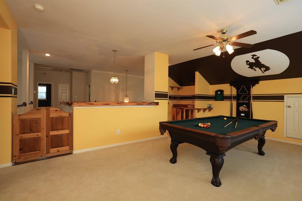 Solid wood cedar swinging bar style doors at entrance to gameroom.