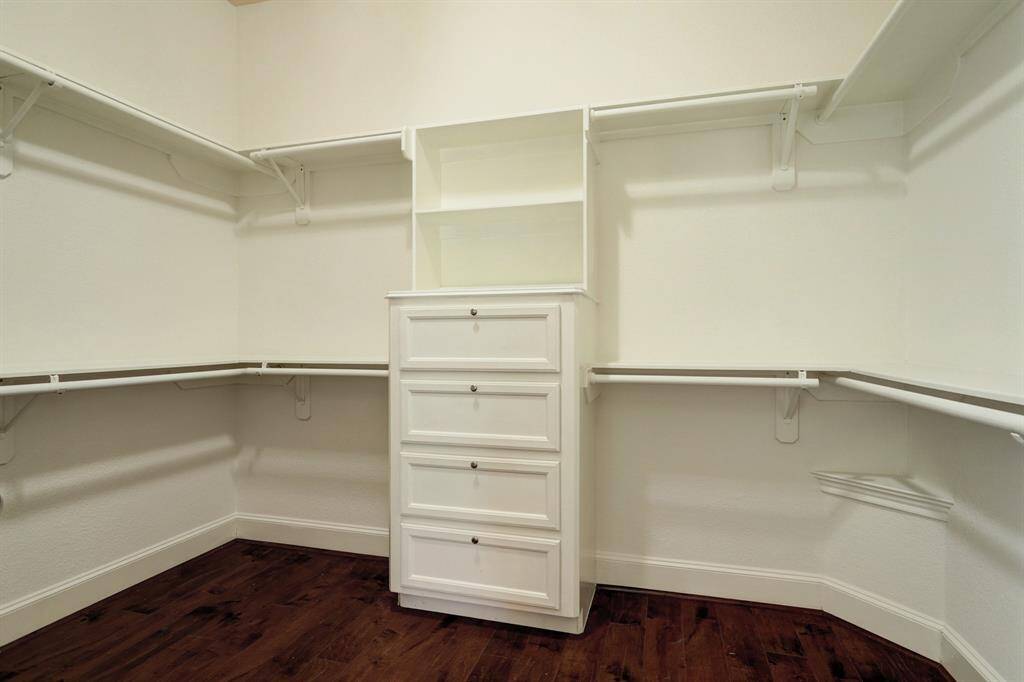 Downstairs master bath offers large walk-in closet with built in drawers