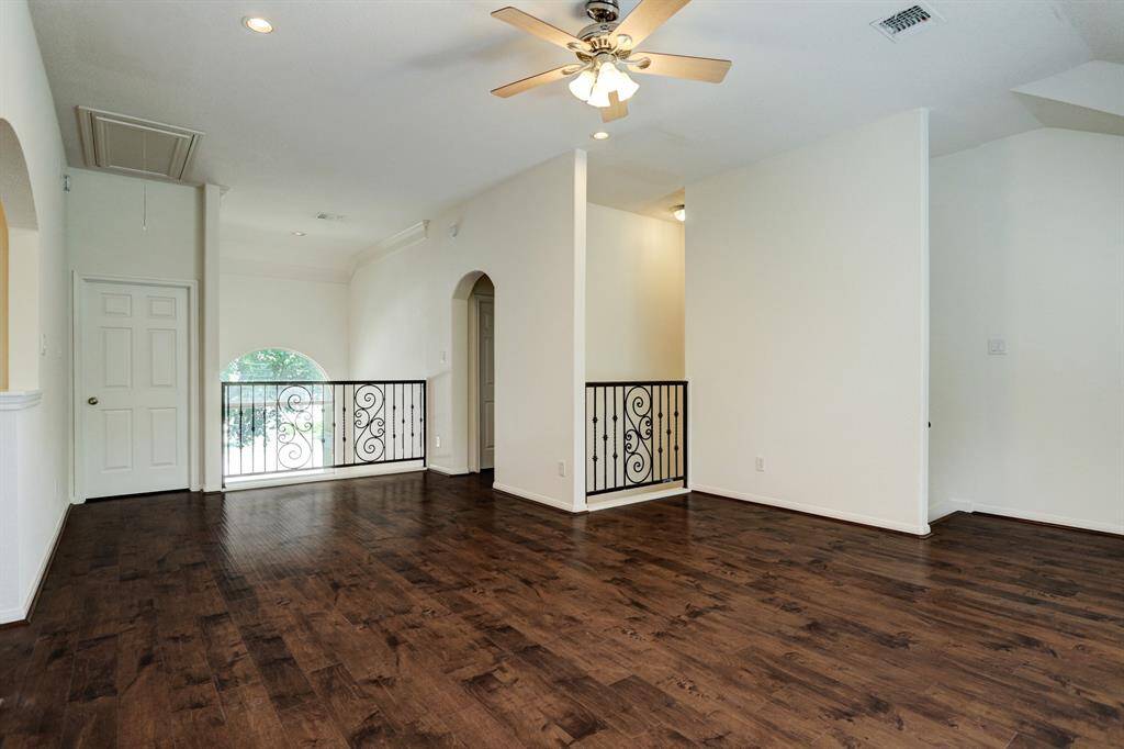 Upstairs open game room with plenty of light overlooking entryway. This open space provides flex space on the second floor.