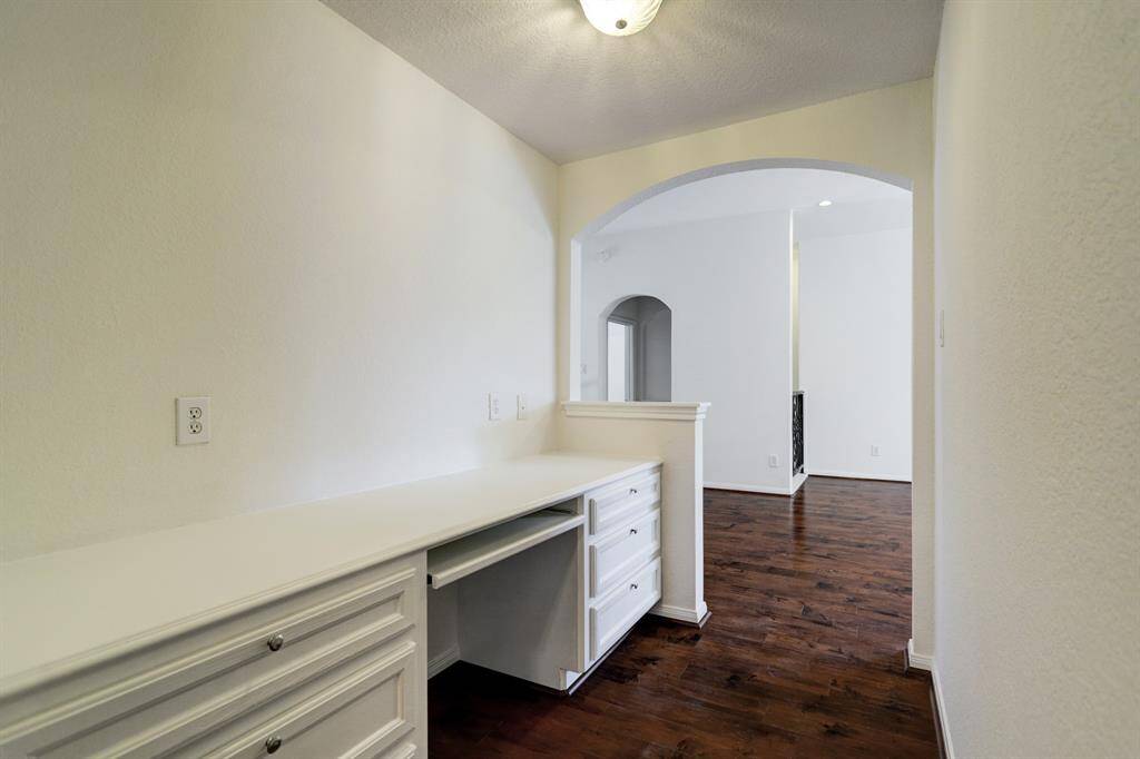 built in workstation for office equipment and storage on the second floor open area .