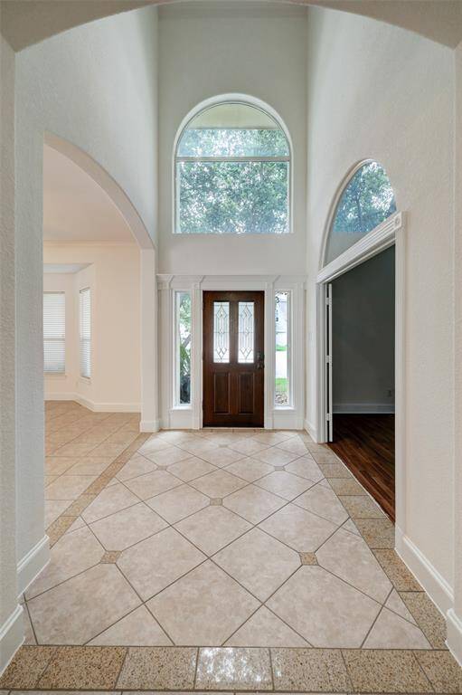 Double Ceiling front entry with Schlage combo lock. This two story high Foyer open to living and downstairs master/ flex area /family room. powder room in foyer hallway.