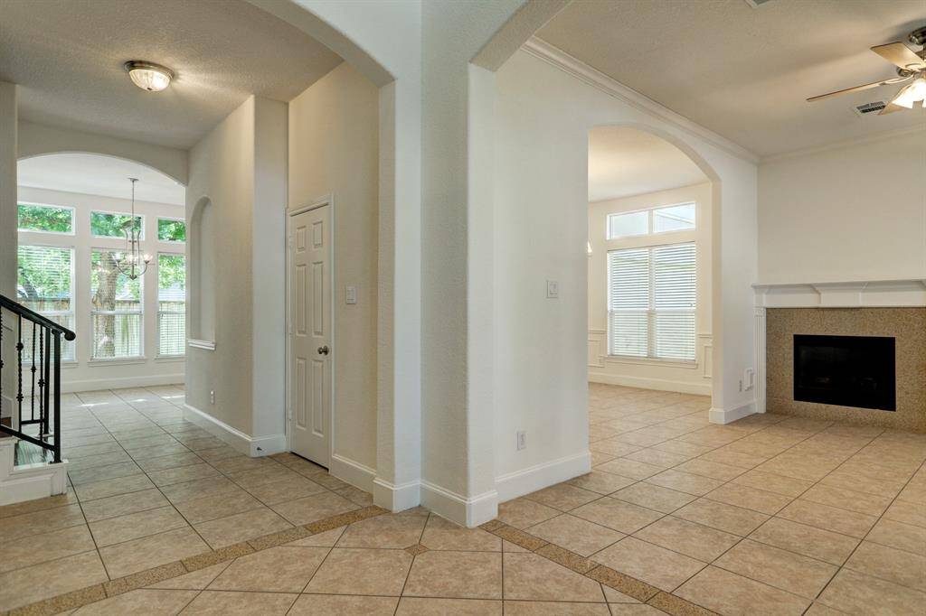 View from two story high foyer. open to living, formal dining and breakfast area.