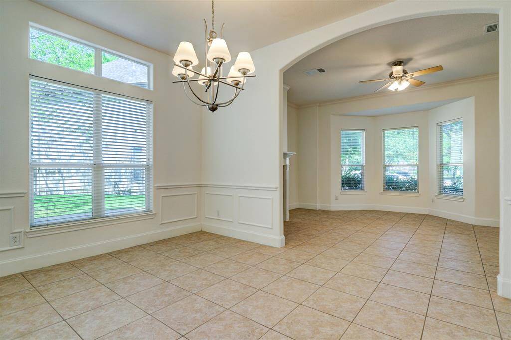 Light and bright formal dining room with transom light windows. Formal living has gas fireplace and bay windows. Ceiling fans in most rooms.
