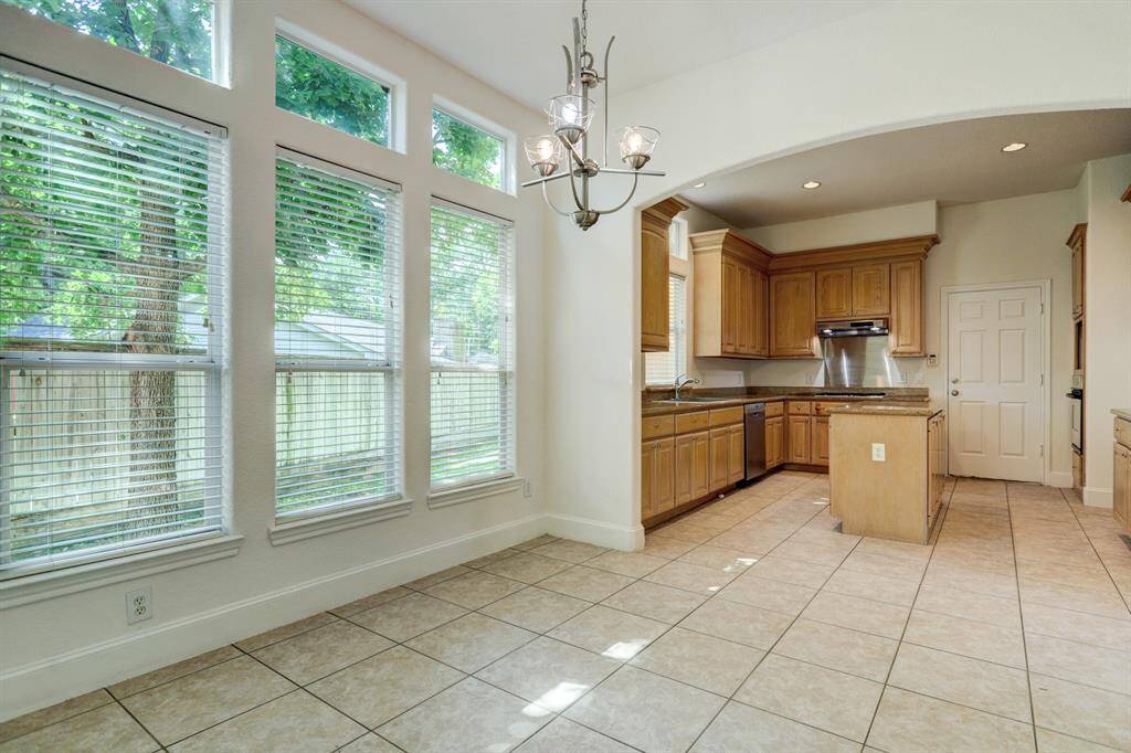Breakfast area with transom windows provide plenty of light shaded by mature Burr Oak tree