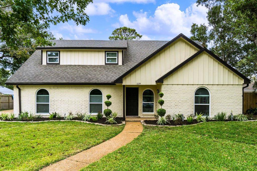 Charming front exterior with fresh landscaping