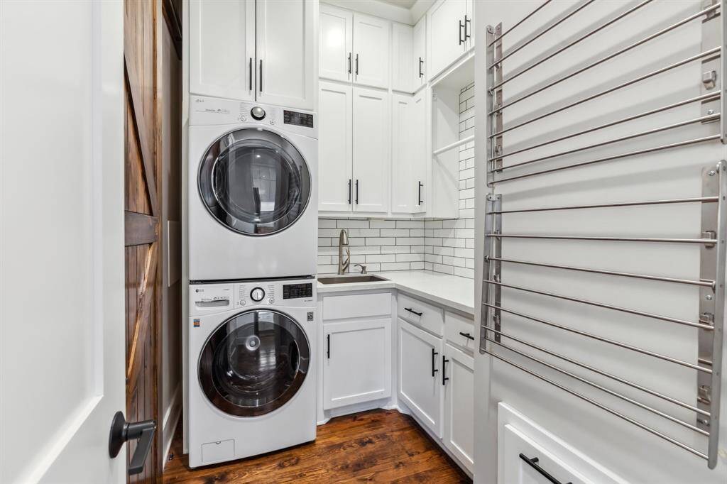 Your Laundry Room is on the first floor off the kitchen and includes a laundry chute to deposit clothes from the primary closet to a waiting clothes bin. Behind the sliding barn door is a walk-in pantry boasting floor to ceiling shelving for ample storage.