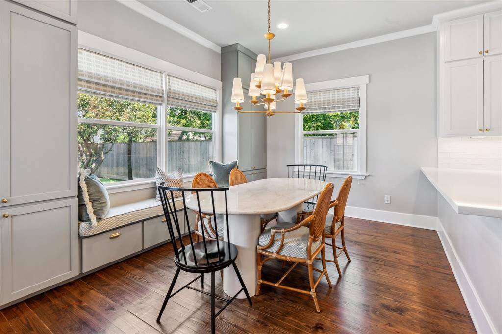 Enjoy morning coffee and casual gatherings in the updated multi-purpose breakfast nook where you’ll find new cabinetry, lovely lighting, large windows with custom Roman shades and a charming window seat with a custom cushion. Built-in cabinets by back door double as mudroom storage and include hidden coat hooks, drawers, and shoe shelving.