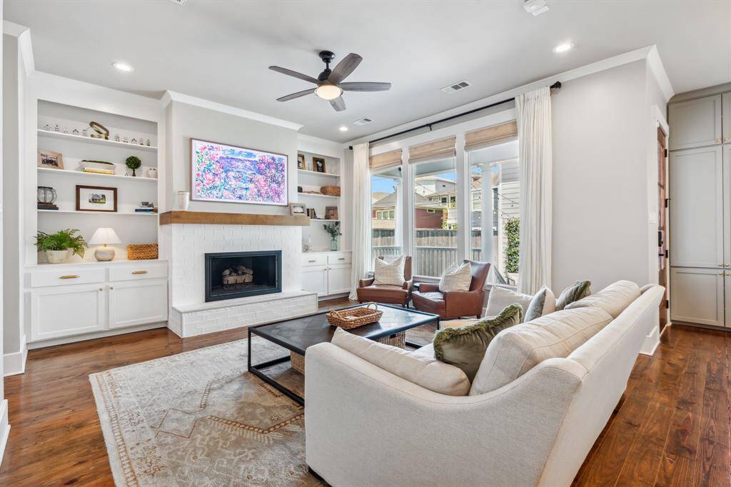Alongside the open kitchen, the family room invites you to relax in front of a warm fireplace flanked by shelving and refaced cabinetry.