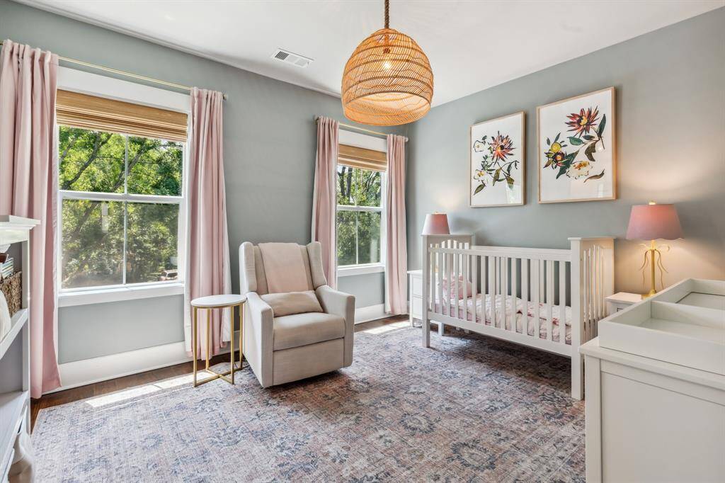 This spacious and bright secondary bedroom boasts two large windows, designer lighting, a roomy closet and access to the upper level’s convenient Jack-and-Jill bathroom.