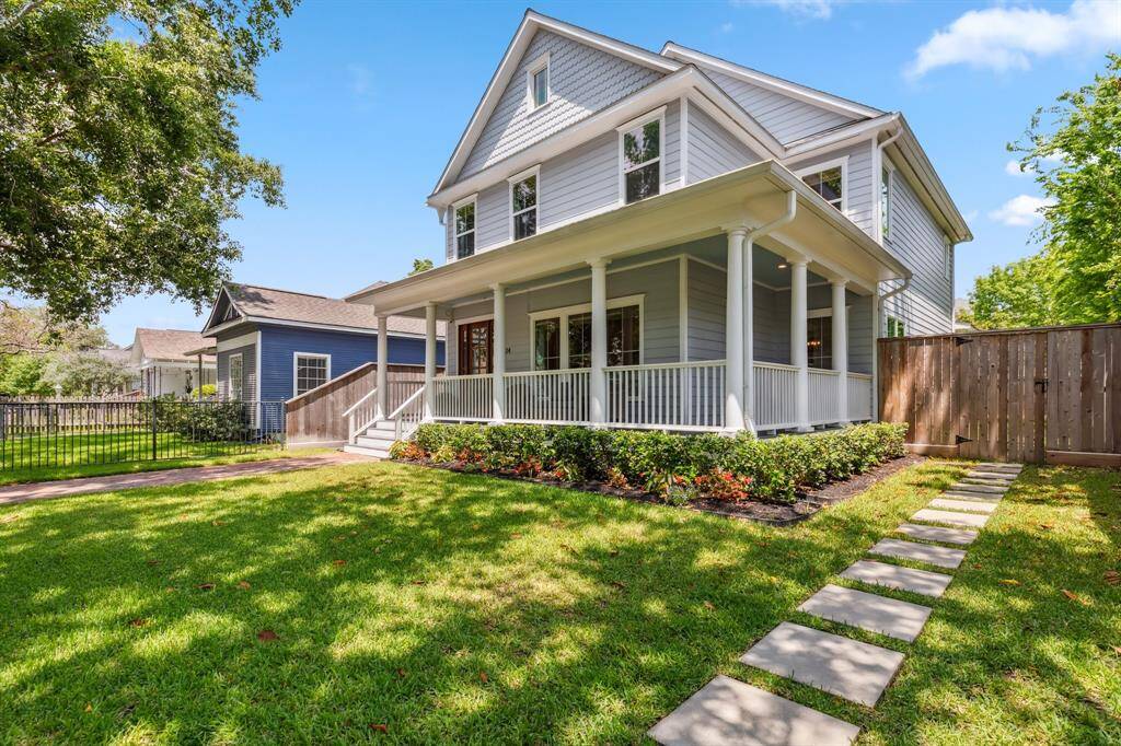 Separate gates and a paver path provide convenient access to the garage apartment, also accessible from the rear alleyway.