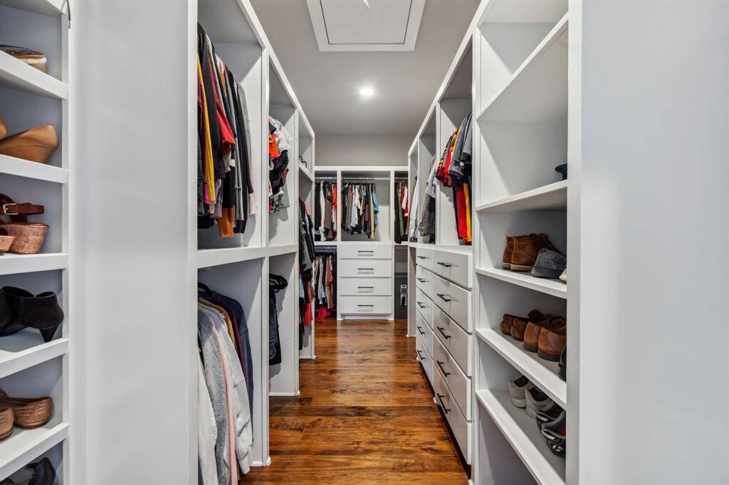Wardrobe storage will never be a concern thanks to the extra-large primary walk-in closet featuring rows of shoe shelving, drawers, double hanging rods and an ultra-convenient laundry chute.