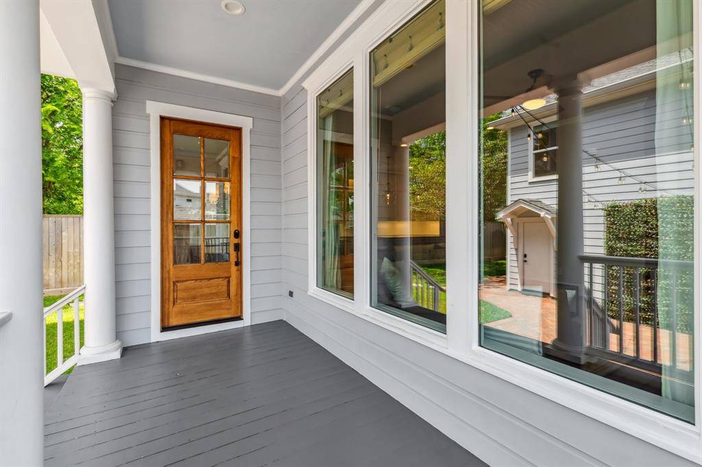 The breakfast nook opens to the rear covered porch overlooking the lovely yard below.