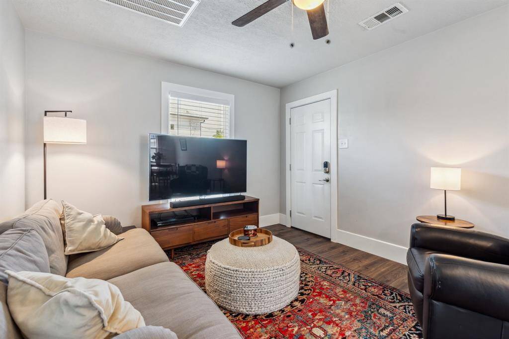 The garage apartment’s spacious living/dining room introduces new flooring, ceiling fans and light fixtures.
