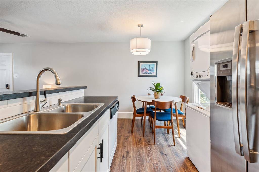 The kitchen’s appliances include a full-size range, side-by-side refrigerator  microwave and dishwasher.