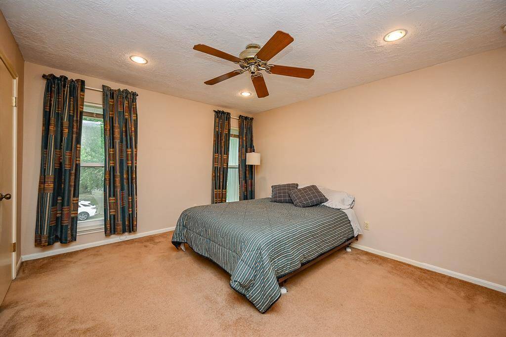 Secondary Bedroom with a view of the front yard trees