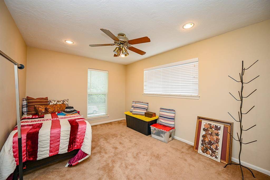 Third bedroom with a view of the backyard