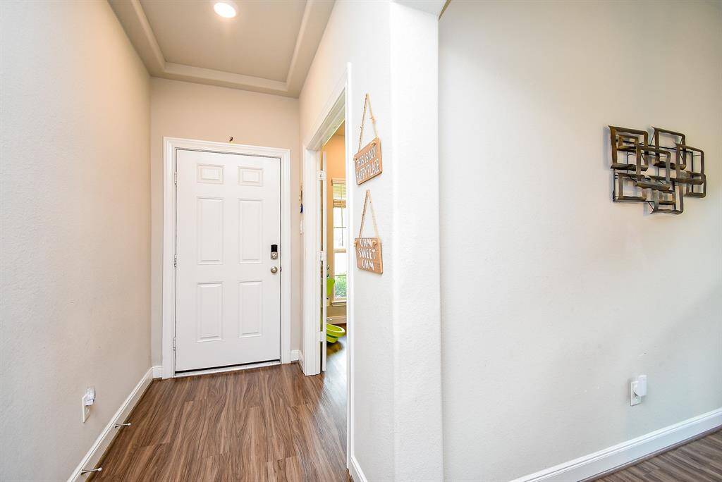 Bright walls and rustic looking floors shine in this inside view of the front entrance.