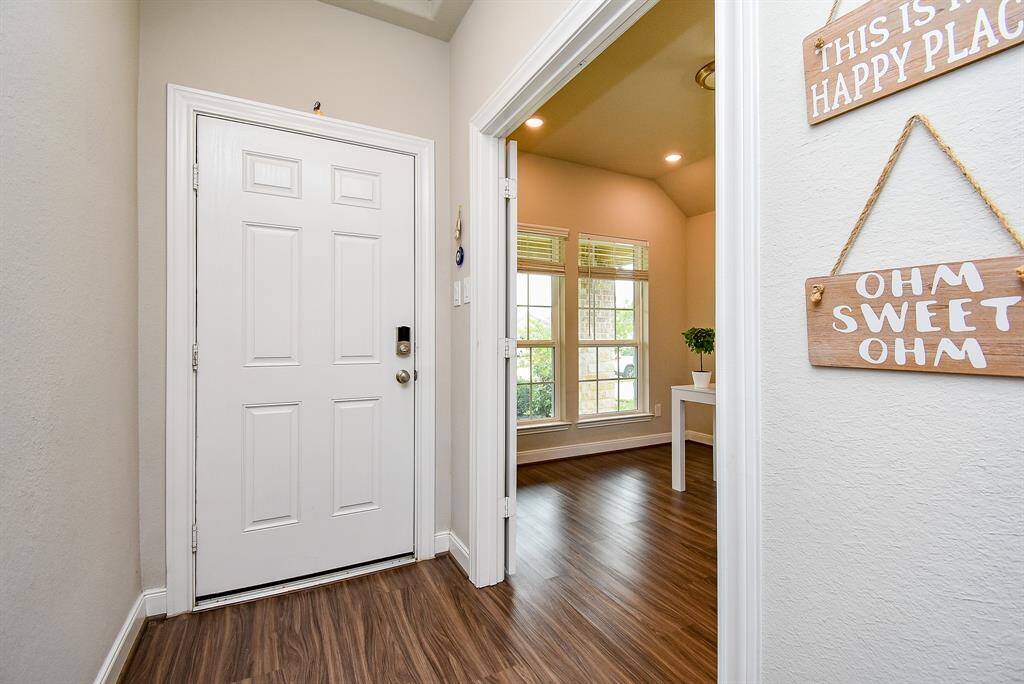 Right off the main entry is this amazing front room (right), perfect as a private home office/study space .