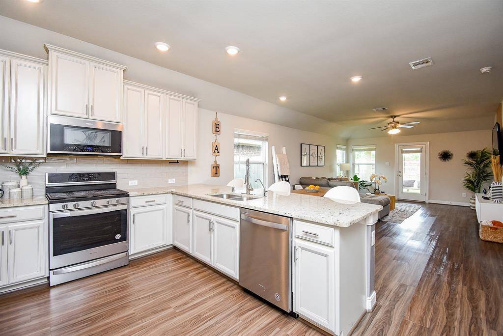 Once again, the open floor plan design concept allows fun socialization from kitchen to living area!