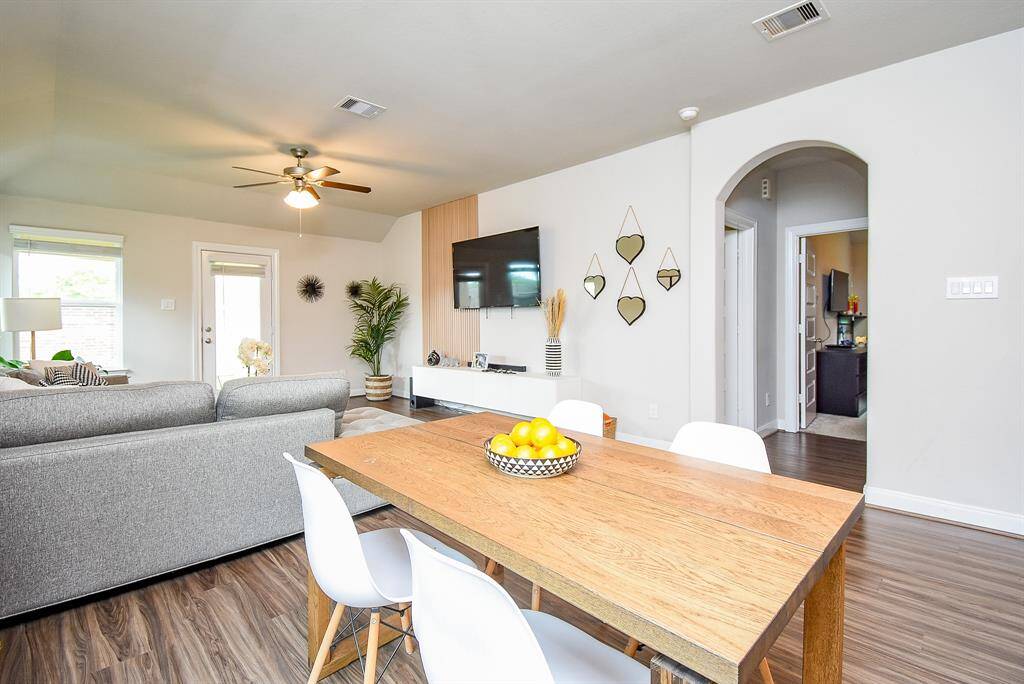 Arched doorways lead to bedrooms off the main living area.